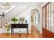 Elegant foyer with hardwood floors, staircase, and tasteful decorations throughout at 2114 Pettigrew St, Sullivans Island, SC 29482