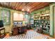 This home office boasts custom built-ins, natural light and an artistic, wood plank ceiling at 2114 Pettigrew St, Sullivans Island, SC 29482