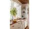 Close-up of kitchen sink and countertop with white cabinetry, brass hardware, and a subway tile backsplash at 2114 Pettigrew St, Sullivans Island, SC 29482