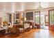 Living room with hardwood floors, stylish decor, and access to the outdoor porch at 2114 Pettigrew St, Sullivans Island, SC 29482