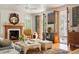 Living room with a fireplace, hardwood floors, decor, and access to the outdoor porch at 2114 Pettigrew St, Sullivans Island, SC 29482