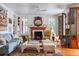 Living room with a fireplace, hardwood floors, and access to the outdoor porch at 2114 Pettigrew St, Sullivans Island, SC 29482