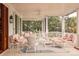 Covered outdoor porch with white wicker furniture and an outdoor ceiling fan at 2114 Pettigrew St, Sullivans Island, SC 29482
