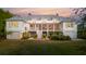 Stunning rear exterior showcasing a multi-story home with a lush, green lawn at 2114 Pettigrew St, Sullivans Island, SC 29482
