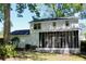 View of backyard with screened in porch, lush greenery, and white painted brick at 212 Blue Heron Dr, Summerville, SC 29485