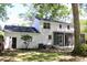 View of backyard with screened in porch, lush greenery, and white painted brick at 212 Blue Heron Dr, Summerville, SC 29485
