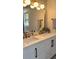 Elegant bathroom features a double sink vanity with gold fixtures, modern lighting, and decorative touches at 212 Blue Heron Dr, Summerville, SC 29485