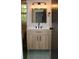 Bathroom with a modern wood vanity, framed mirror, updated light fixture, and hexagonal floor tiles at 212 Blue Heron Dr, Summerville, SC 29485