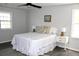 Light-filled bedroom features neutral decor, a ceiling fan, and ample natural light from two windows at 212 Blue Heron Dr, Summerville, SC 29485