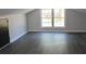 Bright bonus room with wood-look flooring and a double window providing natural light at 212 Blue Heron Dr, Summerville, SC 29485