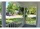 Covered front porch featuring white railings and a view of the landscaped yard at 212 Blue Heron Dr, Summerville, SC 29485