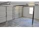 Spacious two-car garage featuring an automatic door and concrete floor at 212 Blue Heron Dr, Summerville, SC 29485