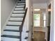 Beautiful staircase with dark stained treads and handrail, complemented by white risers and spindles at 212 Blue Heron Dr, Summerville, SC 29485