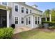 Back exterior of home features a grill, bushes, windows, an AC unit, and greenery at 2308 Watchtower Ln, Charleston, SC 29414