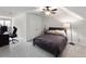 Carpeted bedroom with dark headboard bed, ceiling fan, and large windows by desk area at 2308 Watchtower Ln, Charleston, SC 29414