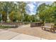 Carolina Bay Park sign with brick pillars and a wood bench on paved walkway at 2308 Watchtower Ln, Charleston, SC 29414