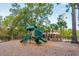 Inviting playground with a slide, nestled amidst trees, with a covered seating area in the background at 2308 Watchtower Ln, Charleston, SC 29414