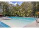 Bright and inviting community pool with shallow entry, surrounded by lounge chairs and umbrellas at 2308 Watchtower Ln, Charleston, SC 29414