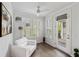 Cozy sitting area with a comfortable chair, hardwood floors, natural light, and a glass-paned door at 2308 Watchtower Ln, Charleston, SC 29414