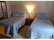 Comfortable bedroom featuring two beds with blue bedding and a nightstand at 237 Driftwood Ln, Edisto Island, SC 29438