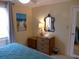 Cozy bedroom with beach-themed decor, including an ocean scene art piece and anchor lamp at 237 Driftwood Ln, Edisto Island, SC 29438