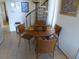 Wicker dining table set for four with spiral staircase in background at 237 Driftwood Ln, Edisto Island, SC 29438