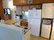 Kitchen area with refrigerator, washer/dryer, and breakfast bar at 237 Driftwood Ln, Edisto Island, SC 29438