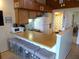 Kitchen area features a breakfast bar with seating, refrigerator, and beach-themed decor at 237 Driftwood Ln, Edisto Island, SC 29438