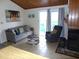 Living room showcasing comfortable seating, access to the deck, and a fireplace at 237 Driftwood Ln, Edisto Island, SC 29438