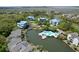 Aerial view of the community featuring a pool and lagoon with mature trees at 2401 Racquet Club Dr, Seabrook Island, SC 29455
