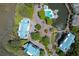 Aerial view of condo community featuring a pool, waterway, and lush green landscaping at 2401 Racquet Club Dr, Seabrook Island, SC 29455