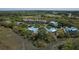 Aerial view showcasing residences, a serene lake, and lush trees in a picturesque waterfront community at 2401 Racquet Club Dr, Seabrook Island, SC 29455