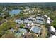 Aerial view of a tennis club featuring multiple courts and a charming clubhouse set amidst lush greenery at 2401 Racquet Club Dr, Seabrook Island, SC 29455