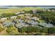 Aerial view of tennis courts, residential homes, and lush green trees near winding waterways at 2401 Racquet Club Dr, Seabrook Island, SC 29455