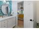 Stylish bathroom featuring blue tile accents, a modern vanity, and an open doorway to the bedroom at 2401 Racquet Club Dr, Seabrook Island, SC 29455