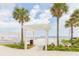 Beach access with lush tropical landscaping, white pergola, and sandy beach with lounge chairs at 2401 Racquet Club Dr, Seabrook Island, SC 29455