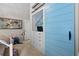 Bedroom with blue accent sliding door, custom built-ins and tv at 2401 Racquet Club Dr, Seabrook Island, SC 29455