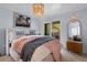 Bright bedroom with stylish decor, including a cozy throw blanket and access to an outdoor balcony at 2401 Racquet Club Dr, Seabrook Island, SC 29455