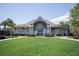 View of the community clubhouse with manicured lawn and landscaping at 2401 Racquet Club Dr, Seabrook Island, SC 29455