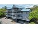 Exterior view of a three-story condo building showcasing multiple balconies at 2401 Racquet Club Dr, Seabrook Island, SC 29455