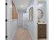 Hallway view leading to bathroom with wooden vanity and round mirror at 2401 Racquet Club Dr, Seabrook Island, SC 29455