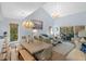 Bright living room with vaulted ceilings, beachy decor, and sliding glass doors at 2401 Racquet Club Dr, Seabrook Island, SC 29455