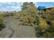 Scenic marsh view of multi-story condominiums surrounded by lush trees and blue sky, offering serene waterfront living at 2401 Racquet Club Dr, Seabrook Island, SC 29455