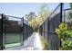 View of a shady walkway to the tennis court at 2401 Racquet Club Dr, Seabrook Island, SC 29455