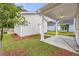 A view of the backyard with a covered patio, green grass, and landscaping at 308 O'Malley Dr, Summerville, SC 29483