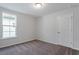 Simple bedroom featuring a window for natural light and a classic paneled door at 308 O'Malley Dr, Summerville, SC 29483