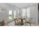 Cozy dining area with a round table, chairs, and bright natural light from the backyard door at 308 O'Malley Dr, Summerville, SC 29483