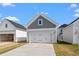 Two-car detached garage with a white door and a concrete driveway for convenient parking at 308 O'Malley Dr, Summerville, SC 29483