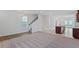 Spacious living room with plush carpeting, staircase, and seamless access to the kitchen area at 308 O'Malley Dr, Summerville, SC 29483