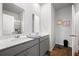 Well-lit bathroom with double vanity, gray cabinets, and a shower with glass doors at 314 Bear Paw Ln, Summerville, SC 29486
